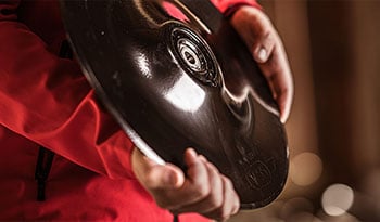 Close-up of someone holding a Väderstad seed drill disc in their hands.