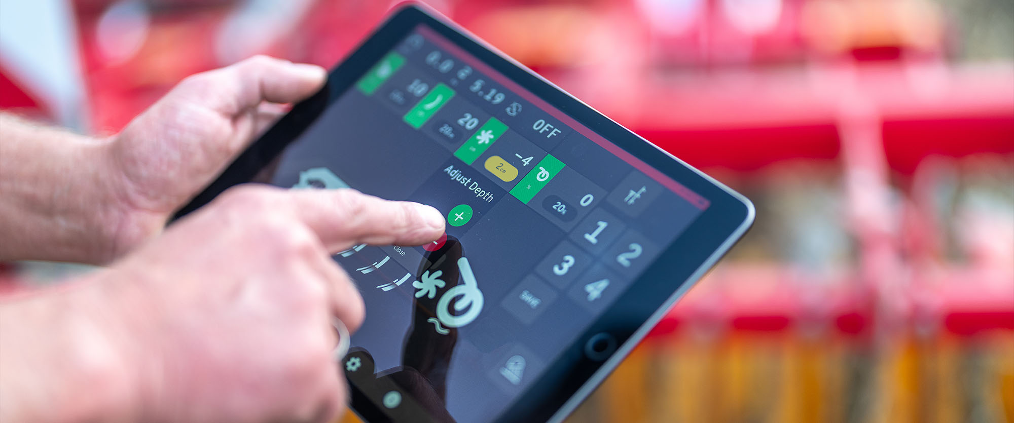 Hand using the iPad-based control system Väderstad E-Control