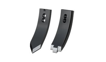 Focus sur des pointes de déchaumeurs Väderstad avec champ en arrière plan