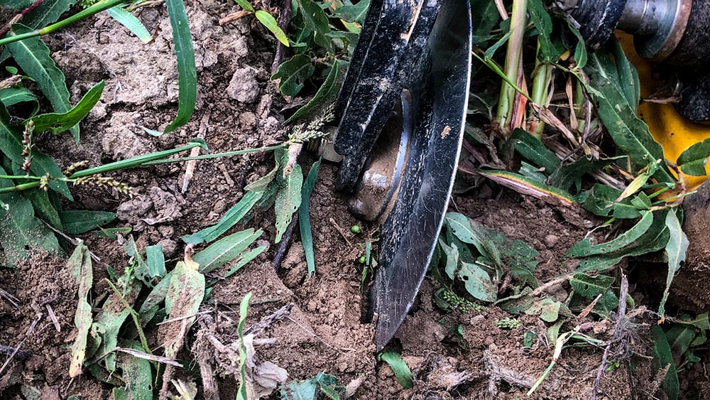 Close-up showing how the Seed Hawk 900C front disc cuts residue in the field.