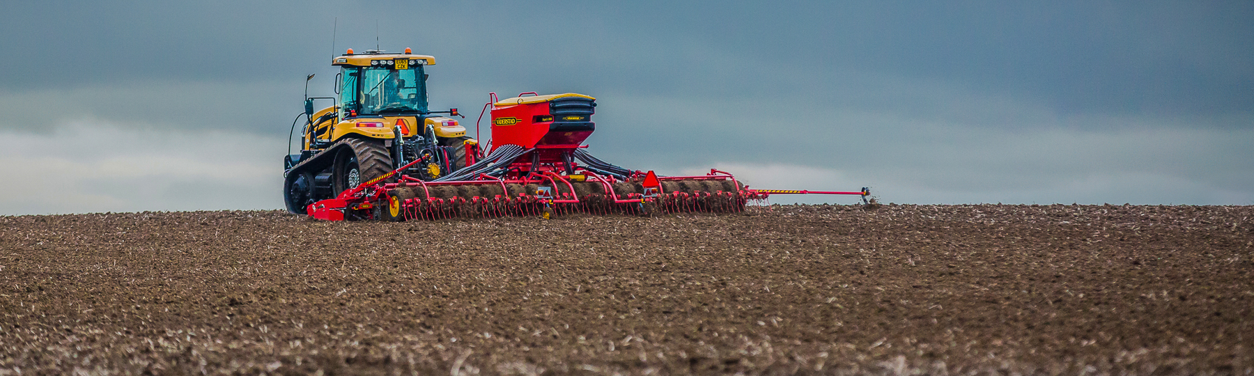 Väderstad Seed drill Rapid A in field under stormy clouds