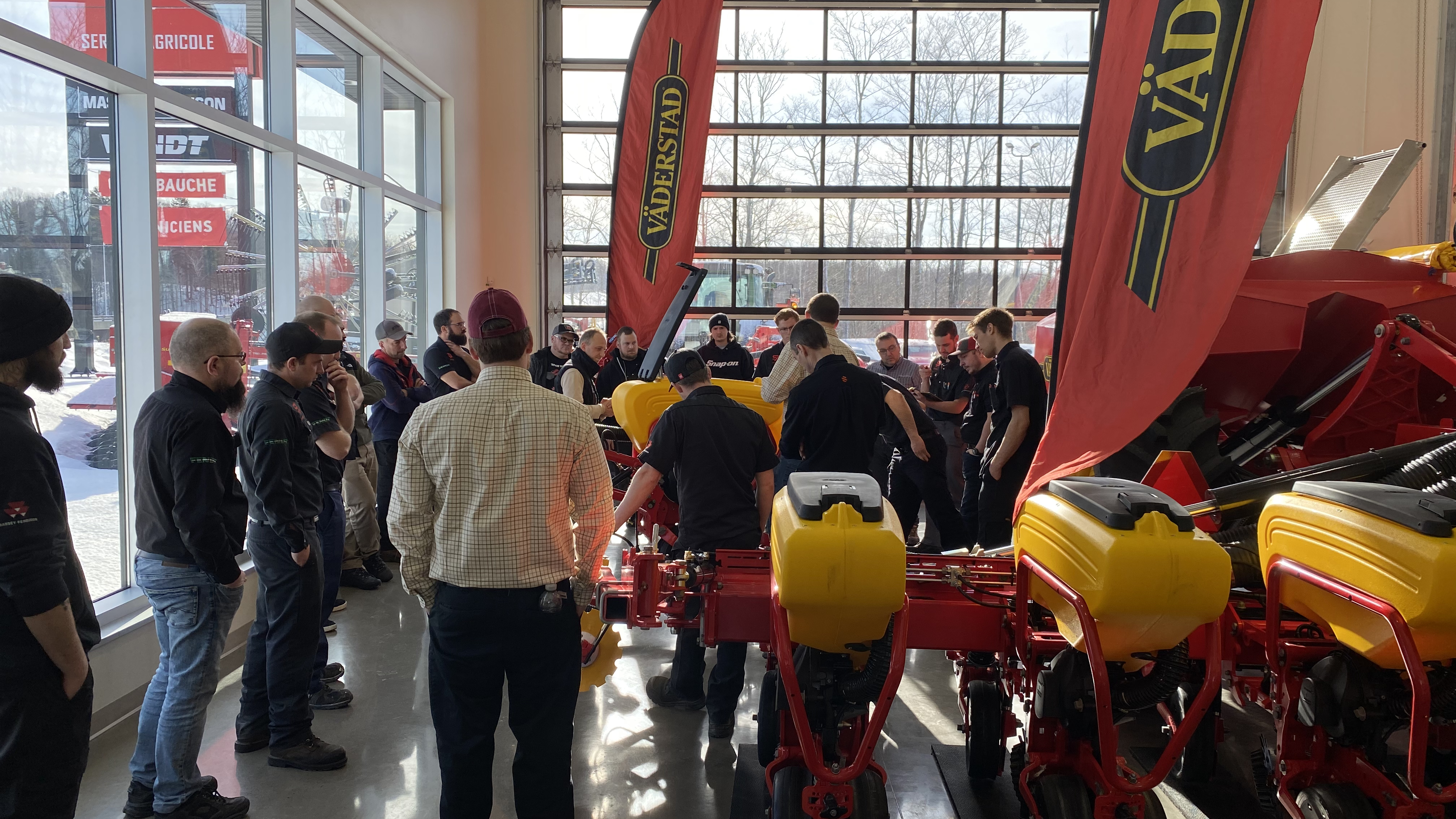 Training group standing in front of machinery