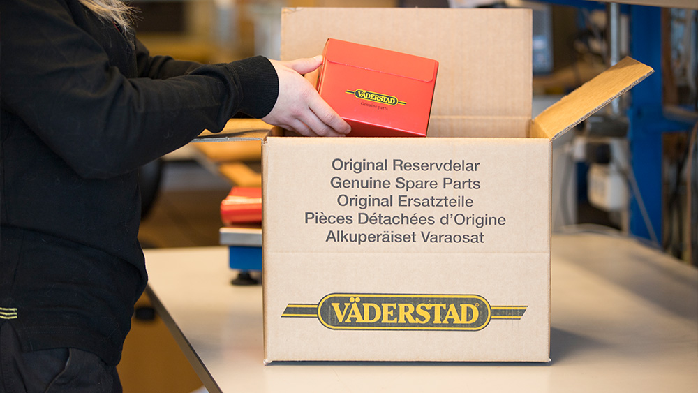 Person putting parts in box